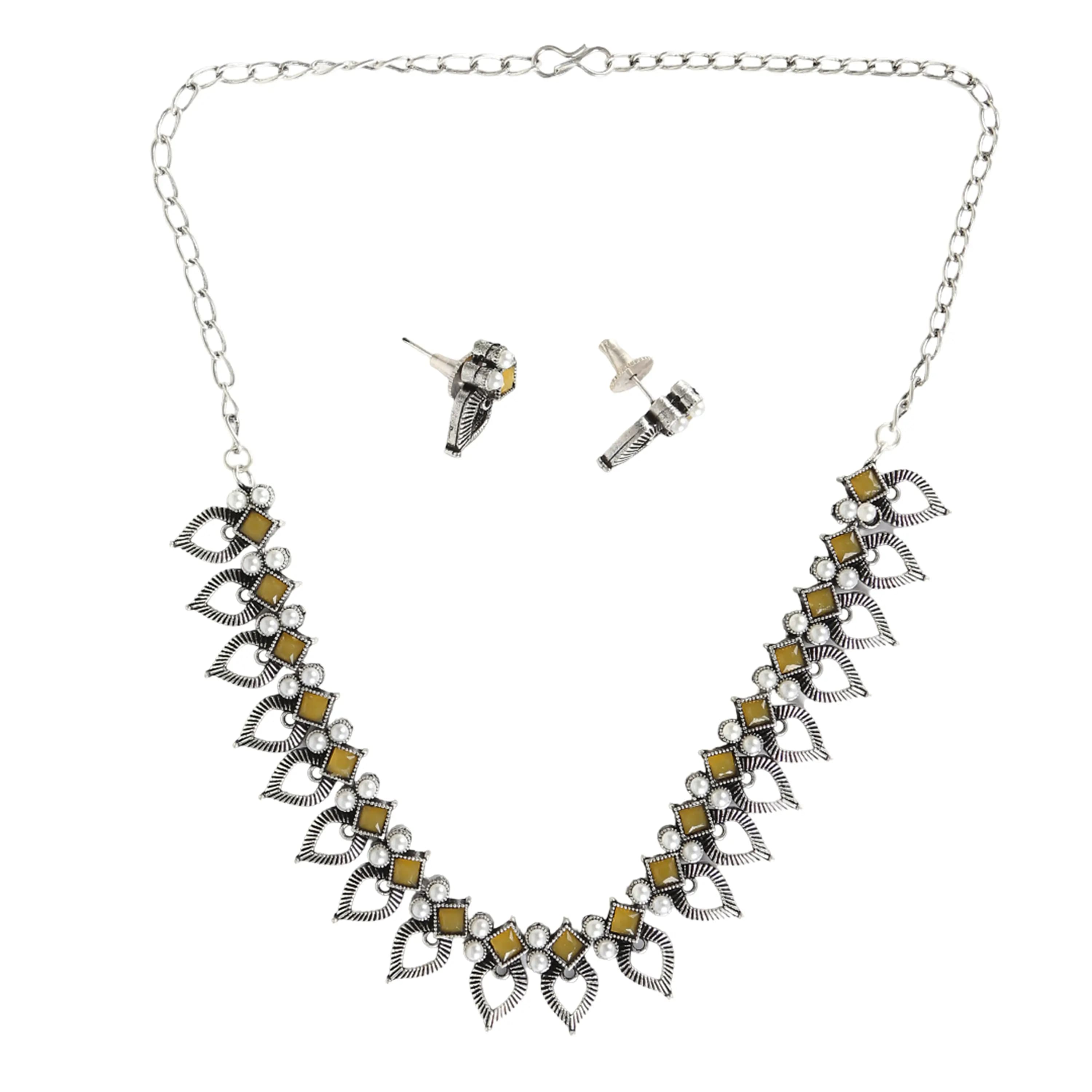 Oxidised silver necklace with yellow stones on white background — jewellery photography