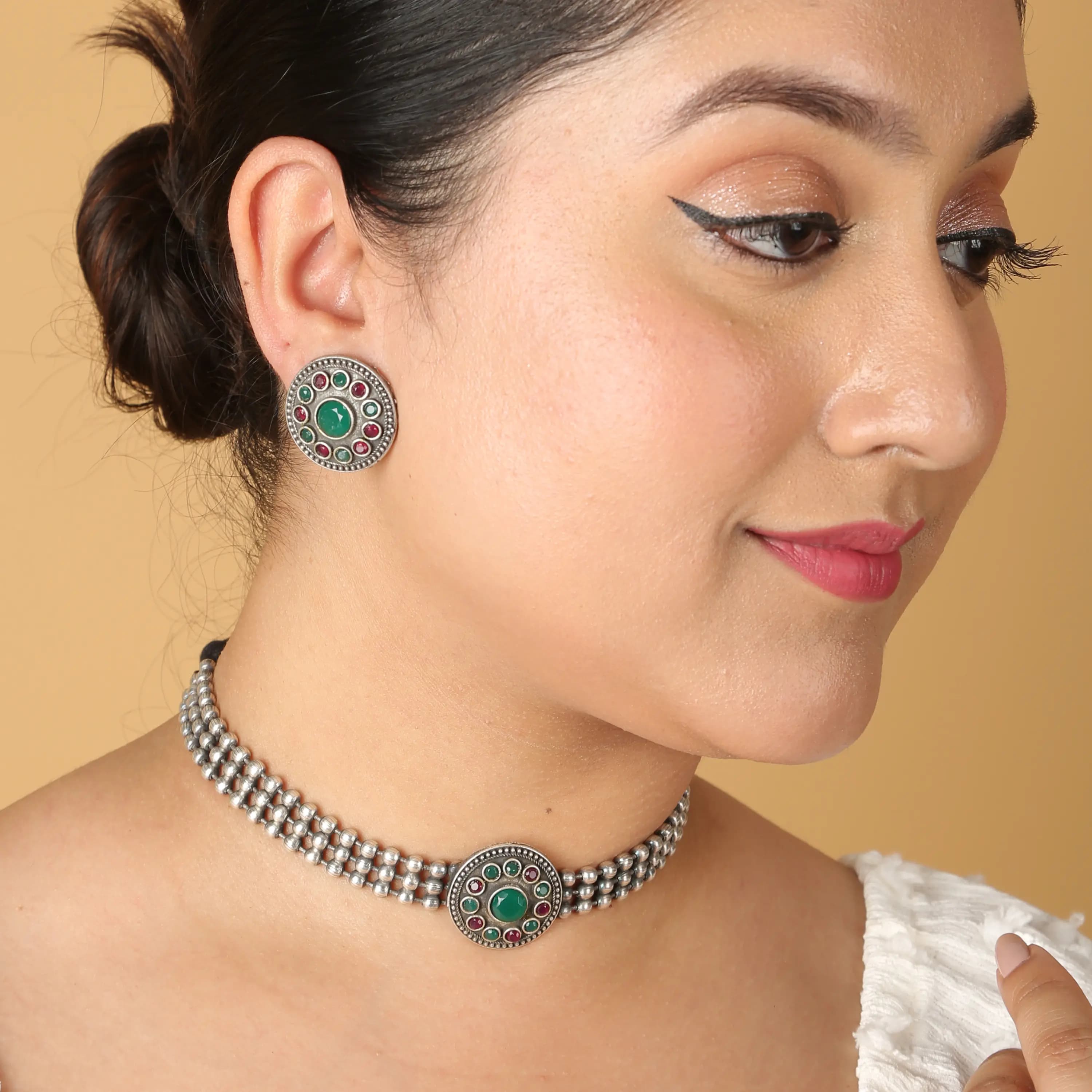 Oxidised silver choker with green stone styled on model — on-model jewellery photography