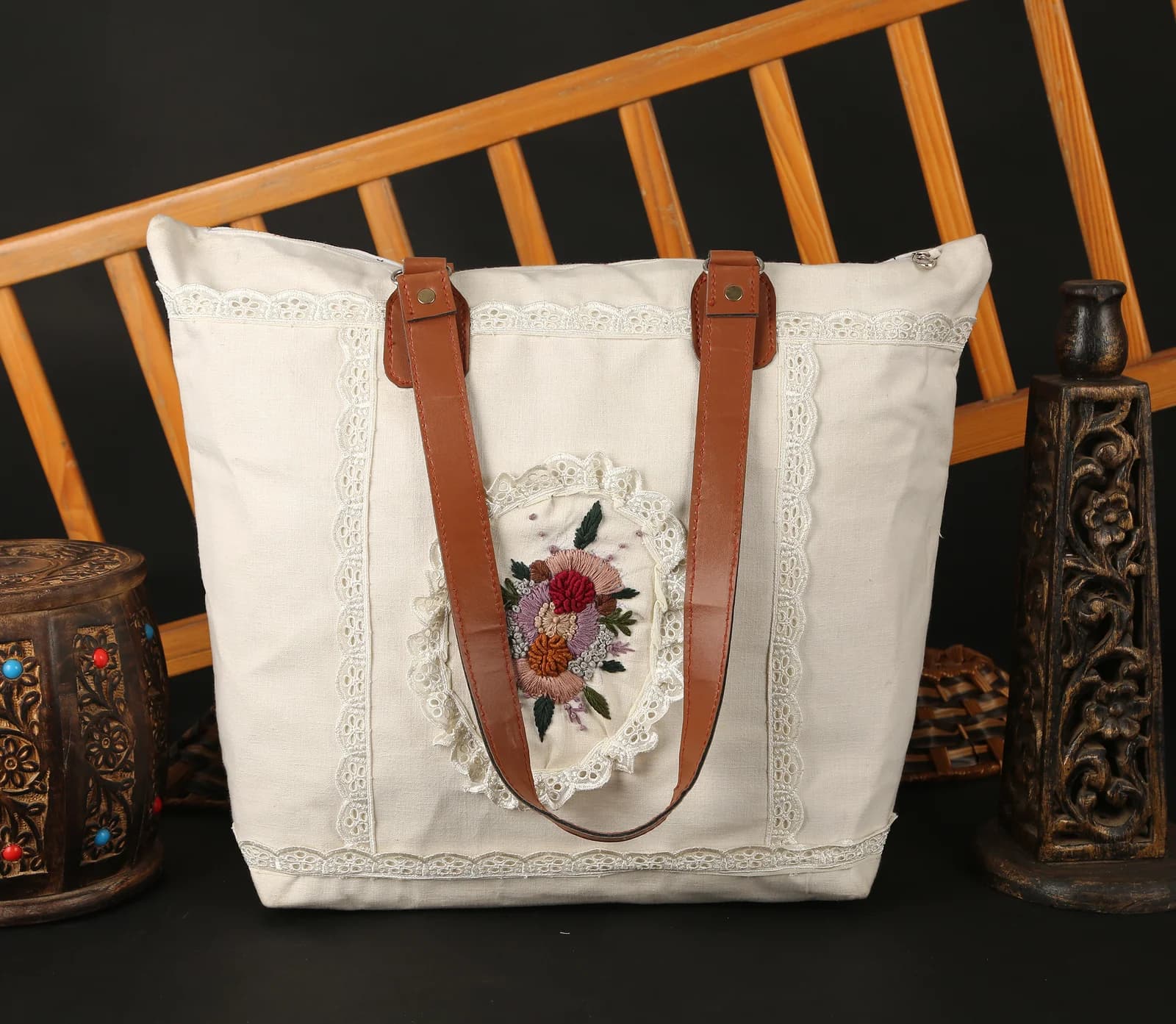 White canvas tote bag with leather straps and floral embroidery — handbag product photography