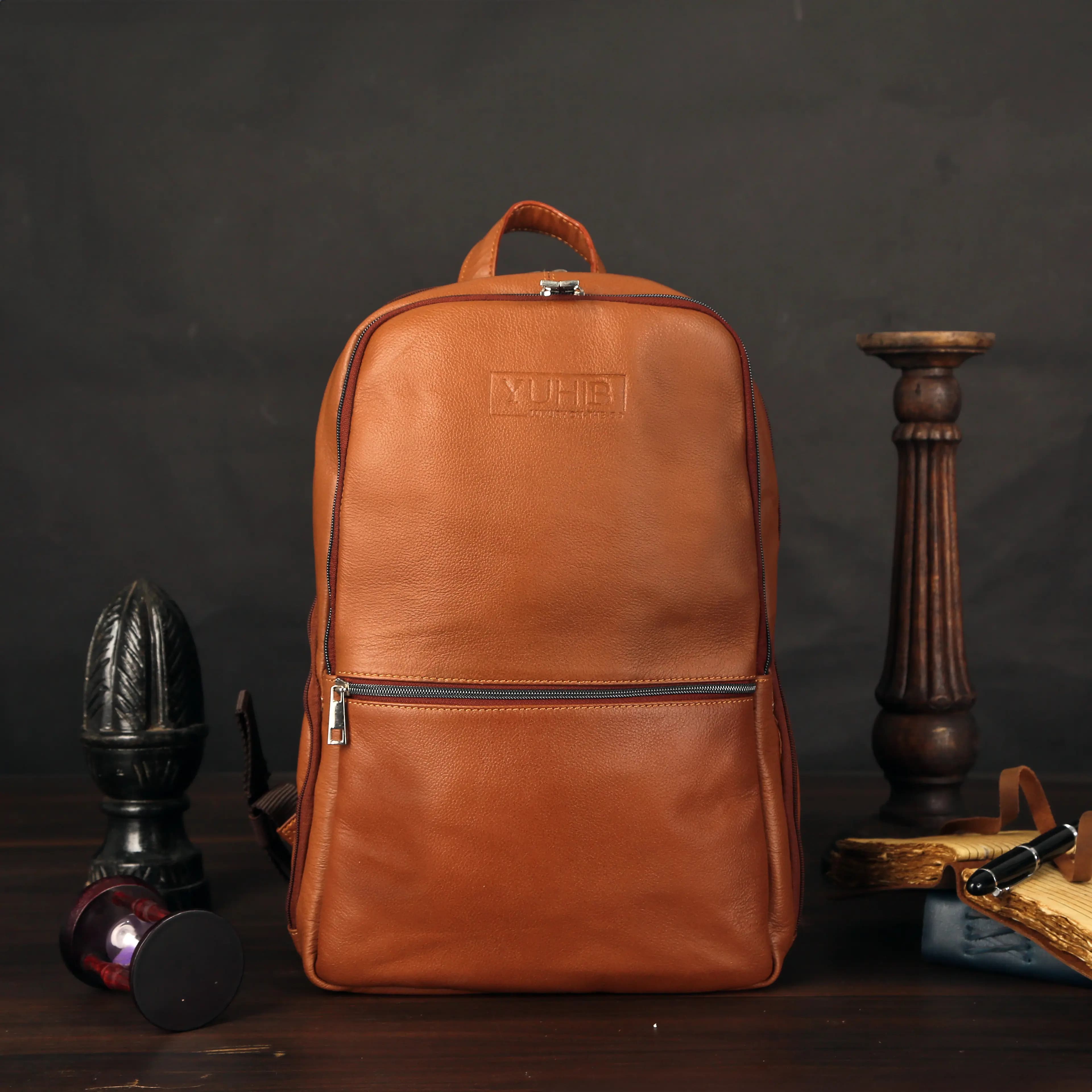 Tan leather backpack on dark backdrop — ecommerce product photography for marketplaces